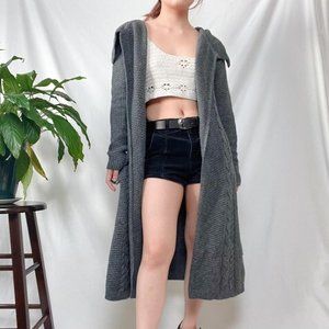Cable knit shawl neck duster length sweater cardigan.